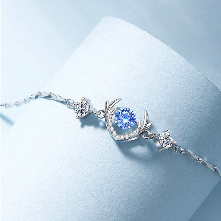 S925 Silver Deer Horn Bracelet featuring blue diamond and silver deer horn design against a soft blue backdrop.